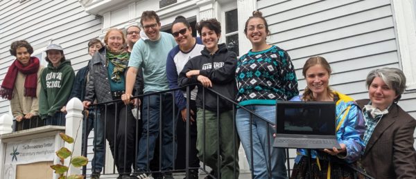 Photo of 2022 Jewish Organizing Fellows smiling outside together on a porch outside a white house.